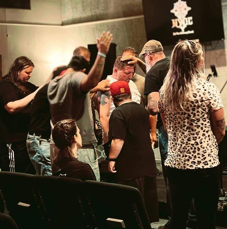 group praying with Jay May